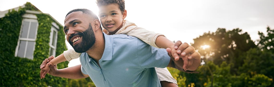 Father flying son on his back.